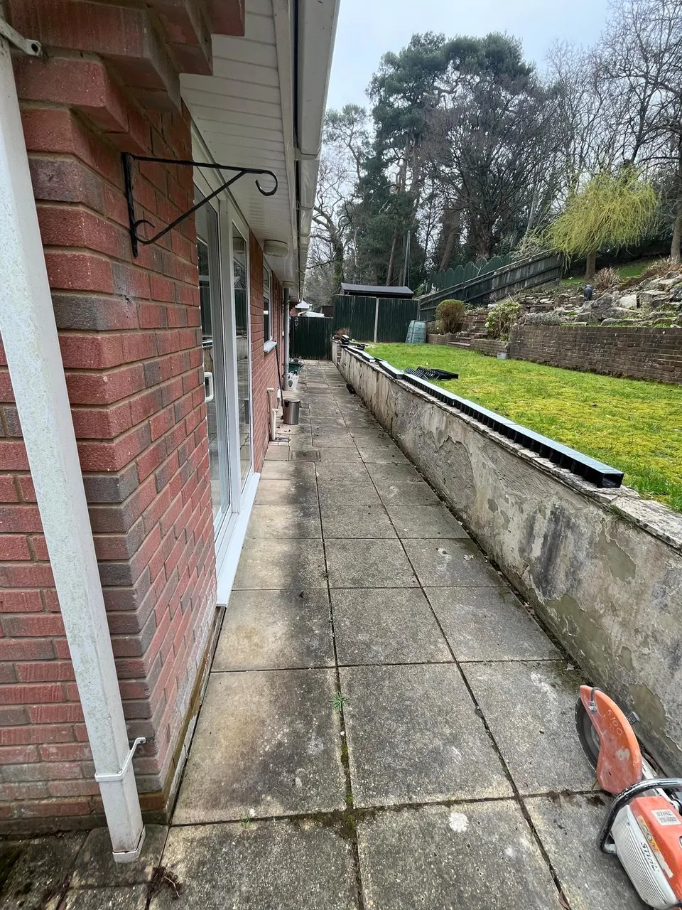Old concrete slab path along the house before the work