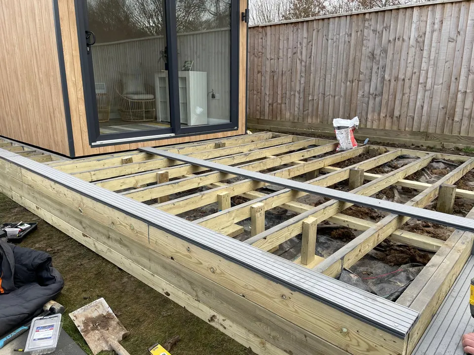 Timber frame for new decking in front of a garden room