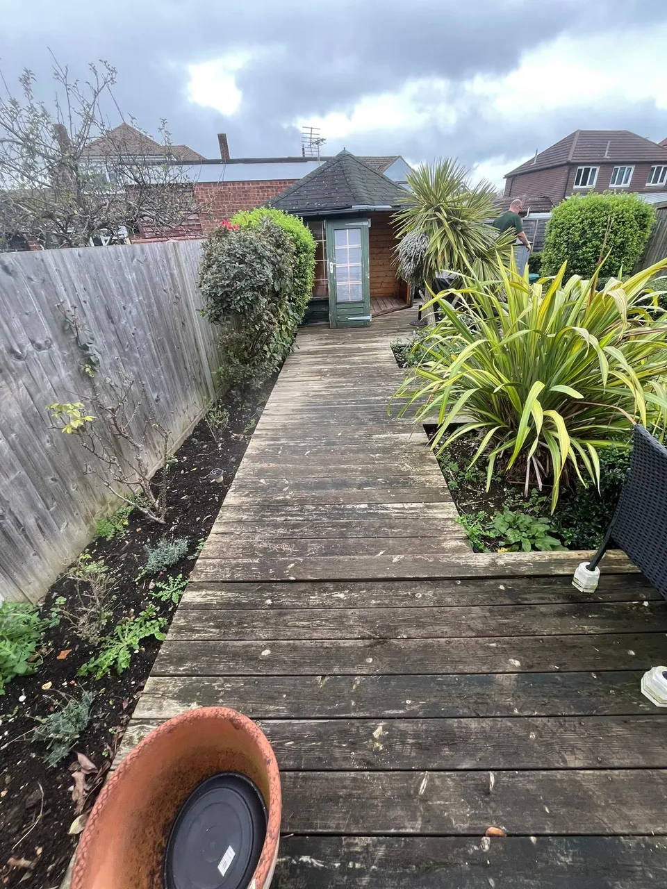 Weathered timber boardwalk down the garden before replacement